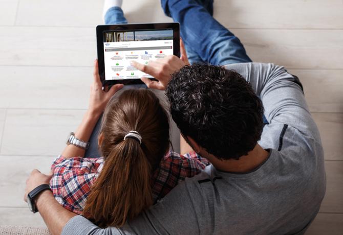 Man and woman looking at GNL website on tablet